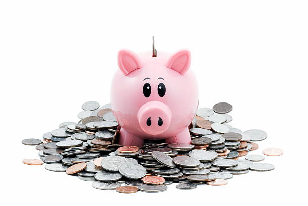 Piggy Bank in Pile of Coins stock photo