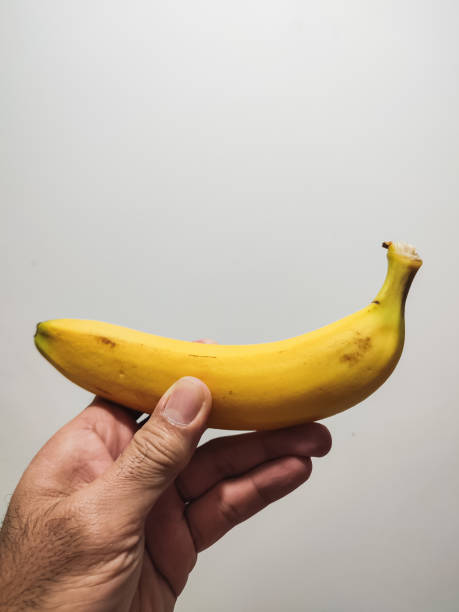 istock A banana in a man's hand. 1404008294