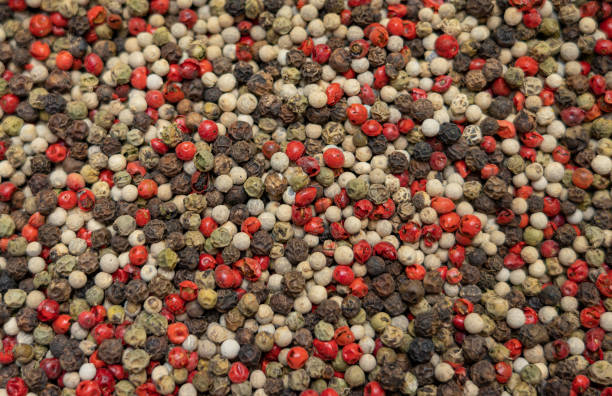 istock Mix of black red and white pepper seeds 1404008325