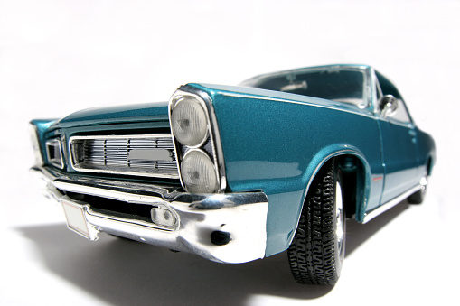 Picture of a 1965 Pontiac GTO. Taken with a fisheye lens picture. Very hard to flash as the frontlens is only 3 cm away from the object.(a lot of reflectors were placed at the sides and round the lens) Detailed scale model from my brothers toy collection.