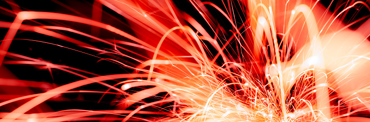 sparks from bonfire over dark night environment, shallow focus