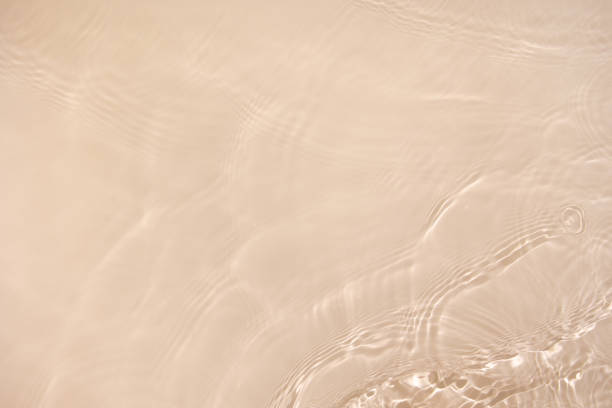 istock transparent beige colored clear calm water surface texture 1404009133