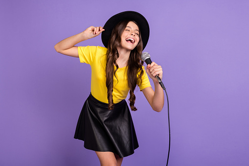 Photo of nice optimistic brunette hairdo girl sing wear cap t-shirt skirt isolated on lilac background.