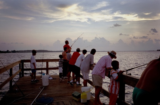 Photo of people fishing at sunset on a Sanibel Island  Florida fishing pier.