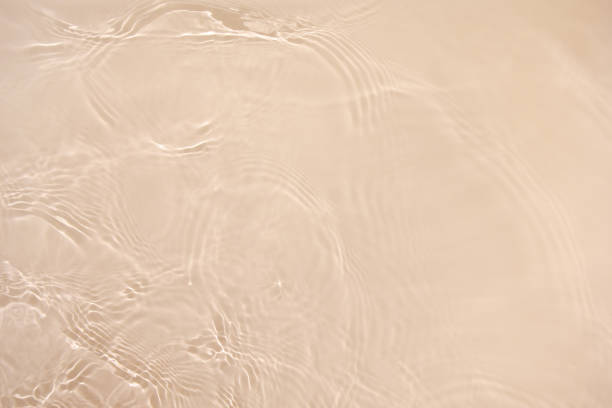 istock transparent beige colored clear calm water surface texture 1404009943
