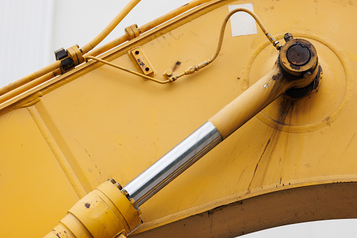 chrome hydraulic cylinder of the old yellow crane. Cncept : maintenence machinery.
