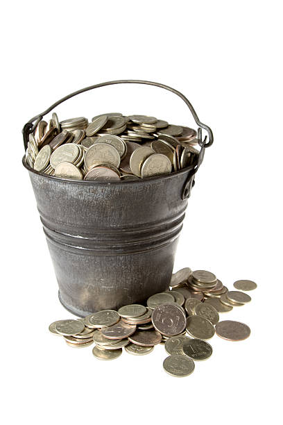 Full bucket of silver coins stock photo