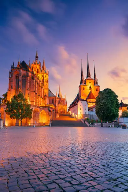 Cityscape image of downtown Erfurt, Germany with Erfurt Cathedral at summer sunset.