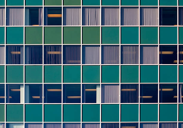 Green wall with windows stock photo