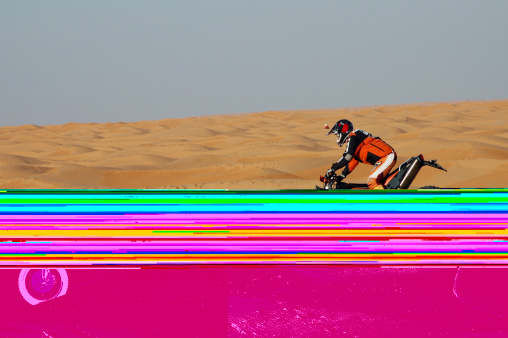 A bike racing in sahara desert. Xar ghilane (tunisia).