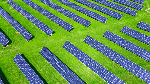 istock Solar panels in green field, aerial view 1404016314