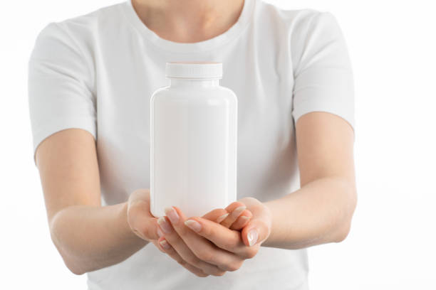 istock Close up image of woman holding a white bottle 1404018863
