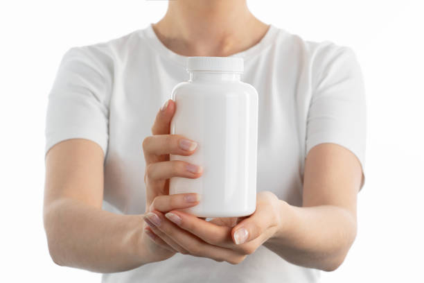 istock Close up image of woman holding a white bottle 1404018942