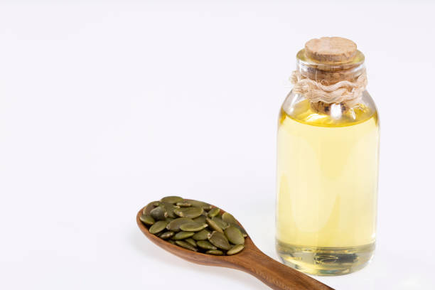 istock Organic Raw Shelled Pepitas And Pumpkin Seed Oil 1404019274