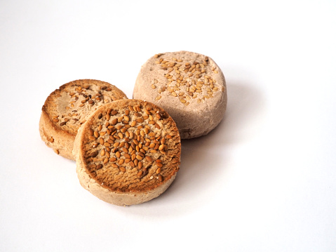 3 Polvoróns with sesame seeds isolated on white background. View from above. copy space. Traditional Spanish treat for Christmas.