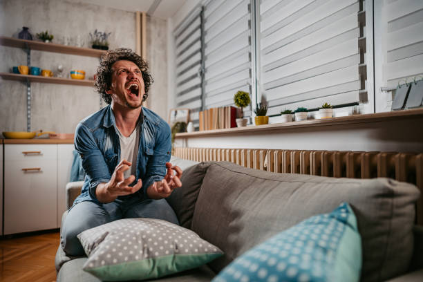istock Depressed And Angry Young Man Screaming 1404019881