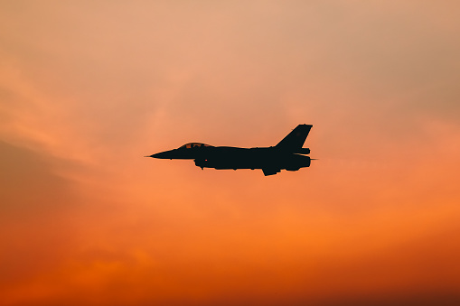 F16 airplane on the background of a beautiful sunset