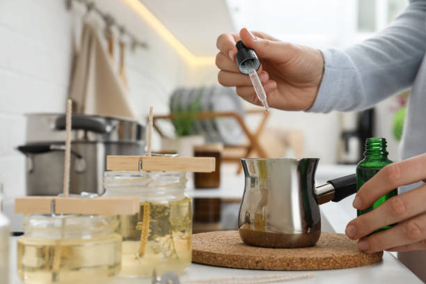 istock Woman making aromatic candles at white table indoors, closeup 1404022778
