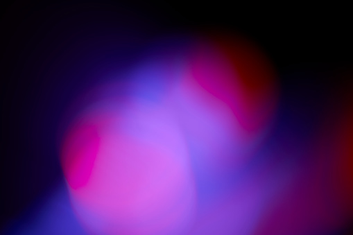 Abstract color gradient defocused light leak on black background