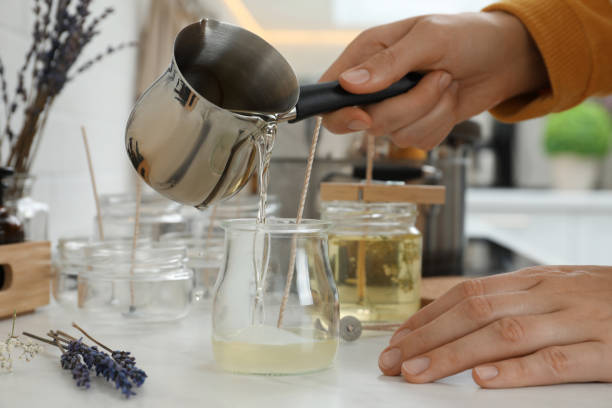 istock Woman making candles at white table, closeup 1404023066