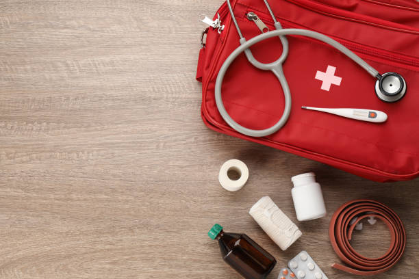 istock First aid kit on wooden table, flat lay. Space for text 1404023636