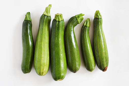 Directly above group of zucchini on the white background