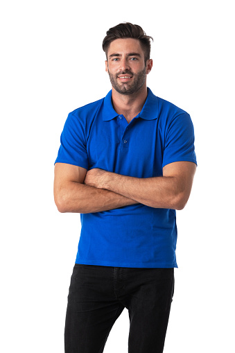 Attractive cheerful young man wearing blue t-shirt standing isolated over white background, arms folded