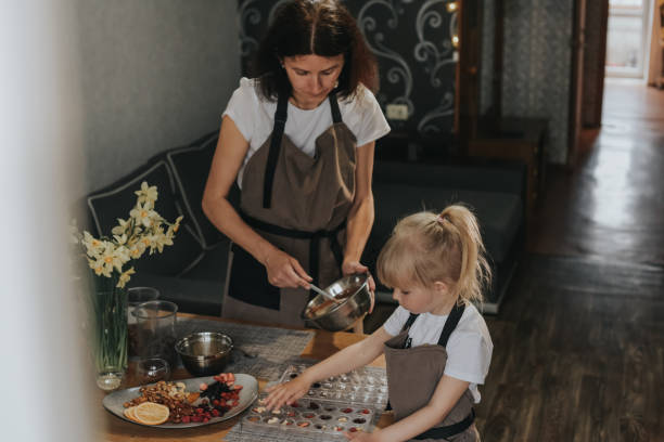 istock Mom and daughter make chocolate at home 1404027296