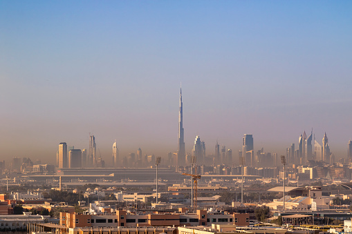 Dubai skyline in the morning from Al Nahda district, during a sandstorm, with airport in the foreground and the financial district in the background