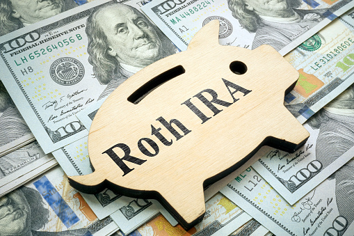 A Piggy bank with sign Roth IRA on money.