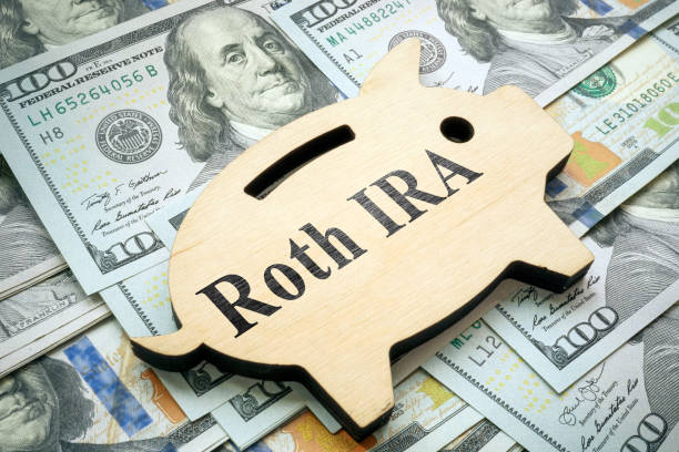Piggy bank with sign Roth IRA on money. stock photo