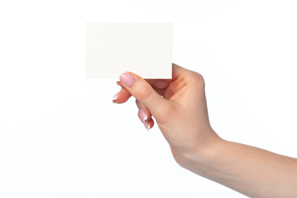 istock Female hand with blank white business card isolated on white 1404029808