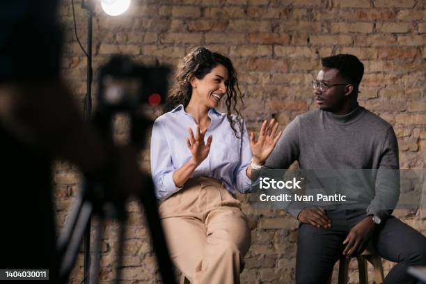 Diverse Couple Of Models Giving An Interview In A Studio Stock Photo - Download Image Now