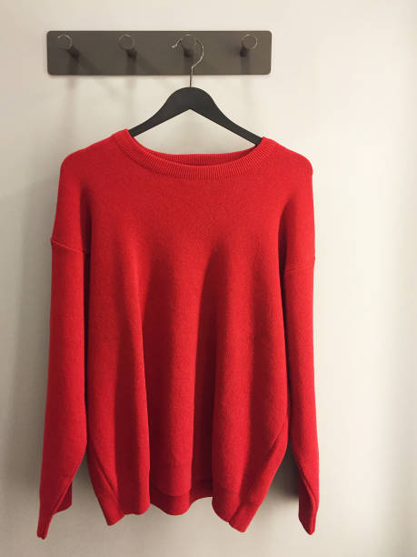 istock Red sweater hanging in the fitting room 1404031831