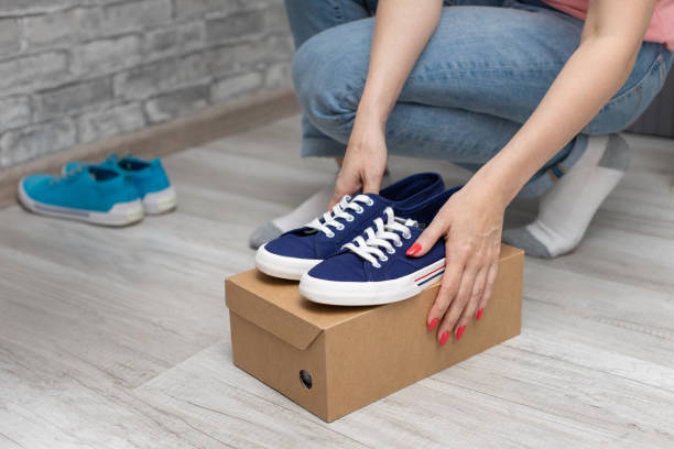 istock girl holding a box with new sneakers 1404034204