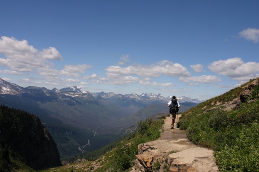 Hiker on Highline Trail along the Garden Wall in Glacier National Park, Montana. This is one of the most senic trails in one of the most senic parks in the US. This shot was taken in July.