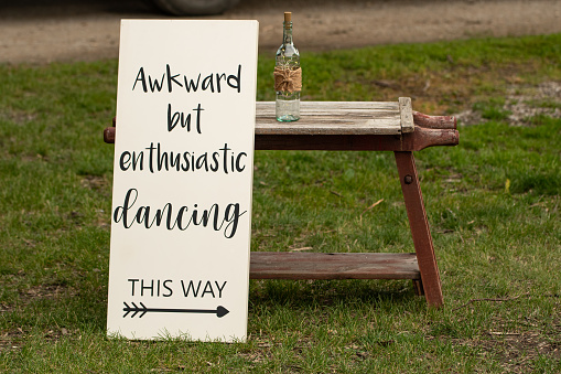This sign promotes happiness and fun at a celebration following a wedding, a true statement for the masses who cant dance but still want to have a wonderful time trying.