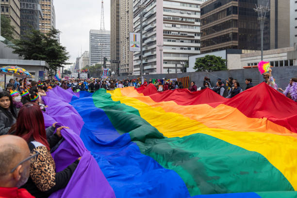 People celebrate on Paulista avenue the 26th Gay Pride Parade, celebration of LGBTQIA+ Pride São Paulo, SP, Brazil, JUN 19, 2022: People celebrate on Paulista avenue the 26th Gay Pride Parade, celebration of LGBTQIA+ Pride sao paulo gay pride parade stock pictures, royalty-free photos & images