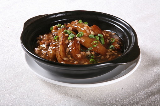 Fish-flavored eggplant in a bowl side view on grey background singapore food