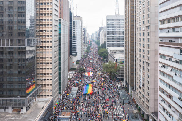 Aerial drone footage on Paulista avenue of the Gay Pride Parade, flag at the LGBTQIA+ Pride party, 26th gay parade São Paulo, SP, Brazil, JUN 19, 2022: Aerial drone footage on Paulista avenue of the Gay Pride Parade, flag at the LGBTQIA+ Pride party, 26th gay parade sao paulo gay pride parade stock pictures, royalty-free photos & images