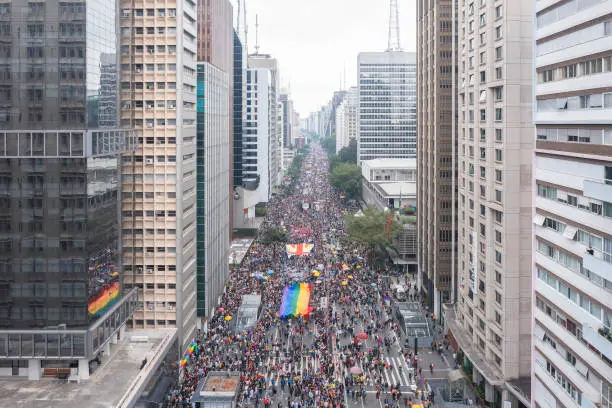 São Paulo, SP, Brazil, JUN 19, 2022: Aerial drone footage on Paulista avenue of the Gay Pride Parade, flag at the LGBTQIA+ Pride party, 26th gay parade
