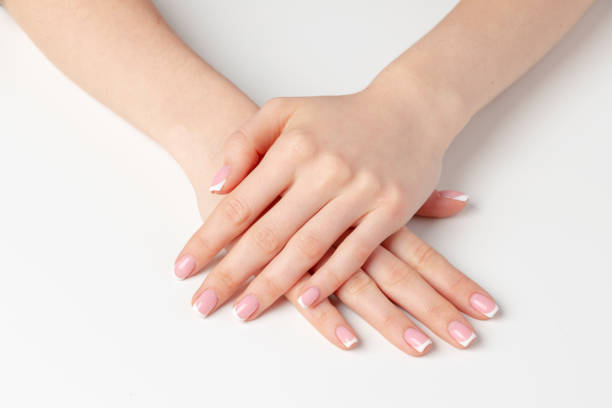 istock Well-groomed female hands with manicure on white background 1404041618