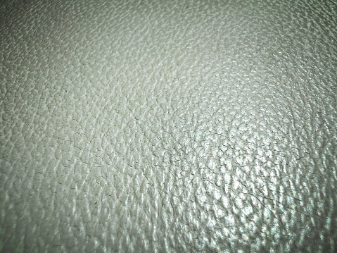 A macro image of a fine white leather.