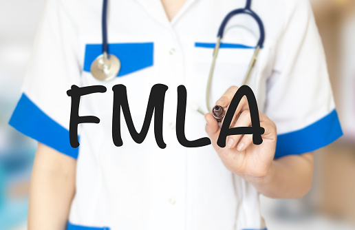 Doctor writing word FMLA with marker, Medical concept