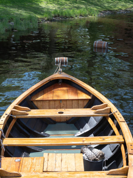 istock A wooden rowboat seen from above as it bobs on the water. 1404043375
