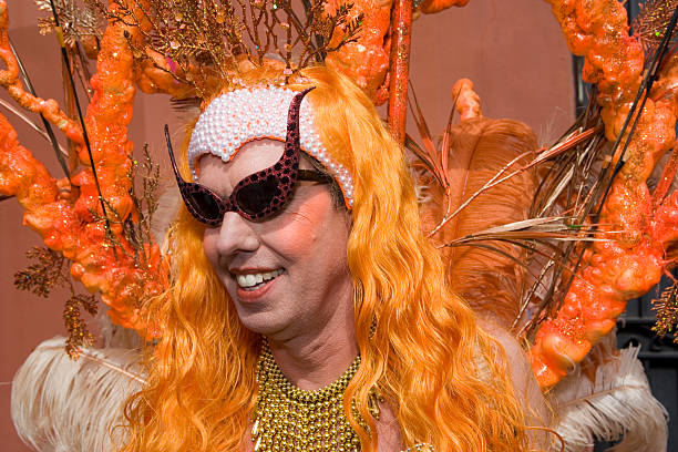 Orange Mermaid Profile Mardi Gras 2007, New Orleans. A man dressed in an elaborate orange Mardi Gras Costume. gay man men sunglasses party stock pictures, royalty-free photos & images