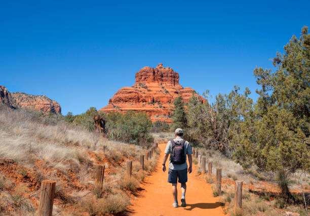 Man hiking in red mountains in Sedona. stock photo