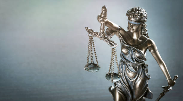 istock Statue of justice blindfolded lady holding scales and sword 1404045061