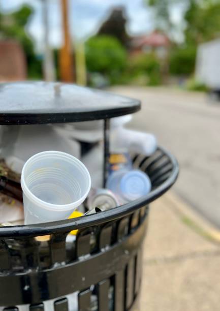 istock Full Trash Can in Urban Area 1404045376