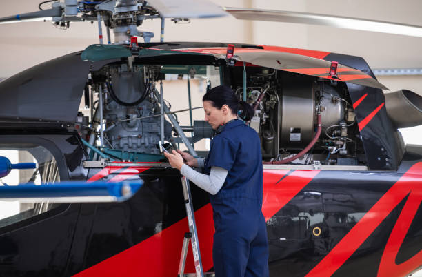 istock Female Aero Engineer Working On Helicopter In Hangar 1404046006